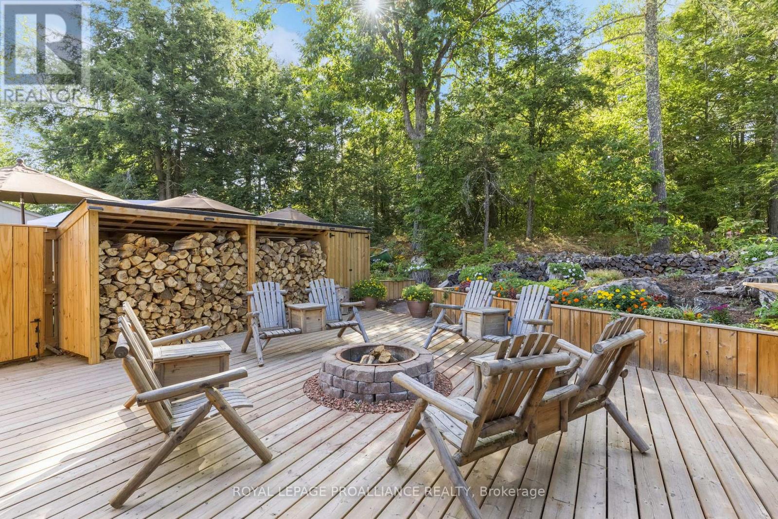 Fire pit deck with Muskoka chairs and gardens